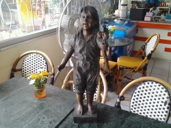 Bronze child holding flowers 59 cm. Signed
