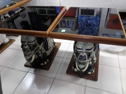 A pair of elephant tables with glass on the top