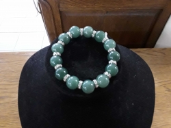 A dark green jade bracelet with stone