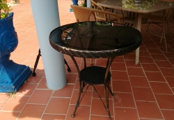 A pair of glass top round tables