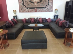 A large leather sofa with cushions