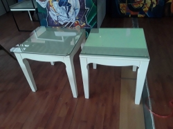 A pair of bedside tables