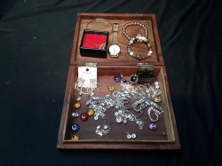A lovely oak with inlaid brass jewelry box with some jewelry