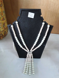 A beautiful seed pearl necklace & stand