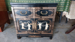 Japanese lacquered cabinet with figure and drawers