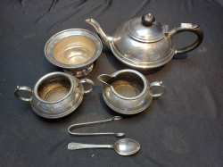 Silver plated tea pot with bakialite handle on stand with sugar bowl and milk jug