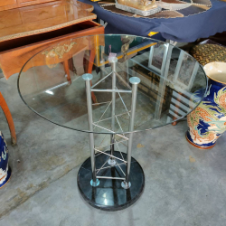 A round table glass top with stainless steel struts with black marble base (Top glass dia.70 cm. / Base dia. 38 cm. and H. 74 cm.