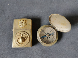 A USMC personalized brass lighter case and a US army pocket compass C.1925