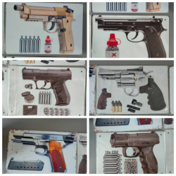 A collection of gun model metal signs 