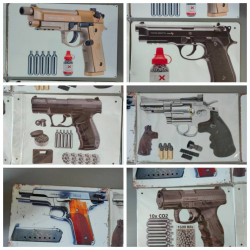 A collection of gun model metal signs