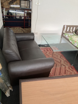 Brown 2 seat sofa with glass coffee table 