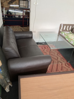 Brown 2 seat sofa with glass coffee table