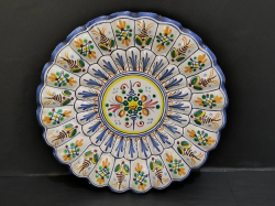 A vtg. Spanish hand painted decorative plate in scalloped shape.