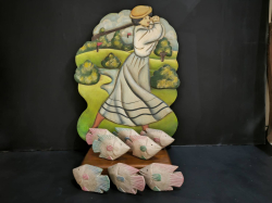 A lovely painted wooden vtg. Lady swinging golf and a school of fishes.