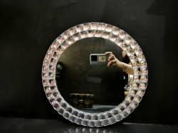A modern style rounded frame mirror decorated with small mirror pieces