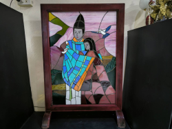 A stained glass panel of Shogun with a lady in a hard wood frame.