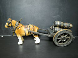 A large porcelain Shire horse pulling wine wood barrel cart