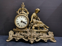 A bronze victorian figural styled chiming mantel clock with enamel dial and key working order