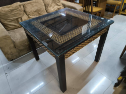 A rattan decorated glass topped dining table square shaped dia 90 cm. 76 cm. height.