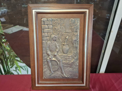 An Imbossed Metal picture of a seated boy. Approx. 32x46 cm
