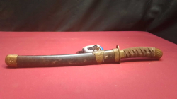 A Japanese Sword Dagger in A Holder.