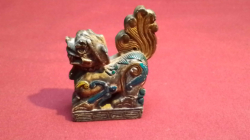 A dark jade carved dog of foo figure with engraved seal to bottom. W.7 H.8 Cm.