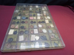 A large display case with 100 vintage Thai amulets.