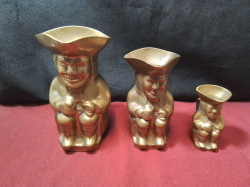 A Set of 3 brass Toby Jugs.