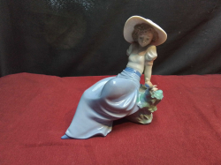 A NAO Figure Girl with A Bird. H.15 W.15 Cm.