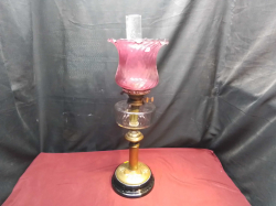 A Large Victorian Brass Oil Lamp with Cranberry Glass Shade. H.66 W.21 Cm.