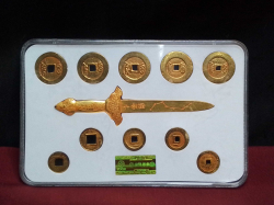 Collection of 10 gold plated old Chinese souvenir coins and beautiful handmade sword ornamen in a case 16x24 Cm.