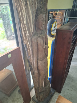 An Old carved tree trunk with a Buddha carving. Approx. H.260 Cm W.55 cm