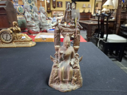 A Bronze sitting Buddha with a small Buddha and birds around