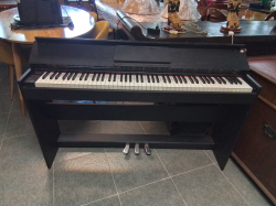 An electric piano 88 weighted keys and foot pedals Etc.