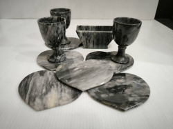 A set of marble drinking set consist of 3 shot glasses , 6 heart shaped coasters and holder.