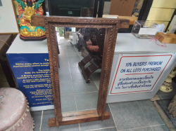 A unique mirror set into an antique hardwood window frame from an old house in the Arabian peninsula. 70x110 cm