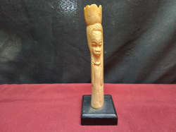 A 19th century antique African carved bone long haired figure on ebony stand 19cm high