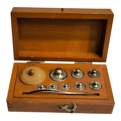 A scale weight set 1930's brass measuring weights.W.6.5 L.11.5 Cm.