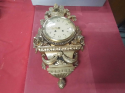 A Nice Swedish Gilt Wall Clock with Pendulum. W.32 H.53 Cm.