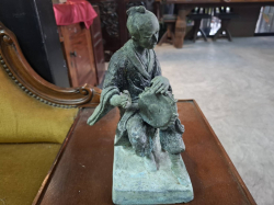 Man playing drum, ancient oriental bronze sculpture.