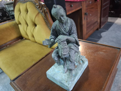 Man playing drum, ancient oriental bronze sculpture.