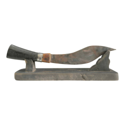 An antique kukri knife on wooden stand