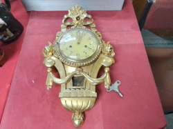 A Swedish Hand Carved Gilt Clock with key and Pendulum 