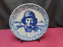 A Vintage 30 Cm. Diameter Delfts Hanging Plate Depicting Old Fisherman with a Pipe, stamped to Base & Stand.