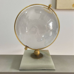 An ornamental etched glass globe hanging on brass standing on marble base H.28 cm. w.14 cm.
