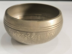 A brass Tibatan singing bowl . W. 10 cm.
