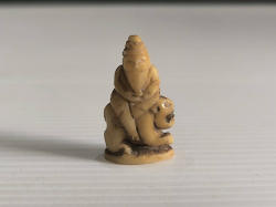 A animal teeth carving fetish , Rue-see riding tiger