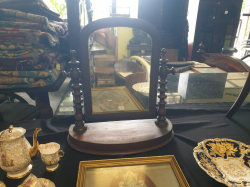 A Victorian Circa 1860 bow front dressing mirror with bobbin turned upright columns with a original mercury mirror