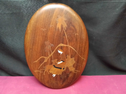 A stunning vintage wall hanging wooden plaque, inlaid with bone and other wood to create a picture of a woman with goat and palm trees 30cm. high