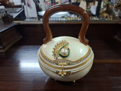 A decorative Ochrich Egg shaped jewelry box /Hand bag features a wooden handle